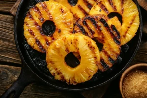 Caramelized grilled pineapple slices with golden grill marks, ideal for pairing with cheese